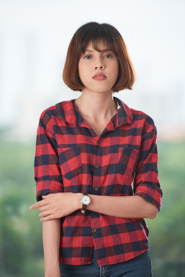 A Woman Looking the Tag on a Shirt · Free Stock Photo