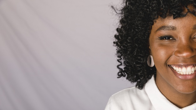 overjoyed,white blouse,looking at camera,toothy,studio shot,copy space,indoors,sincere,closeup,candid,adorable,glad,optimistic,charming,white teeth,joyful,contemporary,confident,cheerful,african american,earring,blouse,leisure,crop,looking,copy,smiling,stylish,pretty,confidence,horizontal,shot,laughing,curly,american,positive,lifestyle,portrait,beautiful,content,young,female,african,studio,grey,lady,gray background,gray,teeth,natural,grey background,white,happy,black,space,camera,woman,background