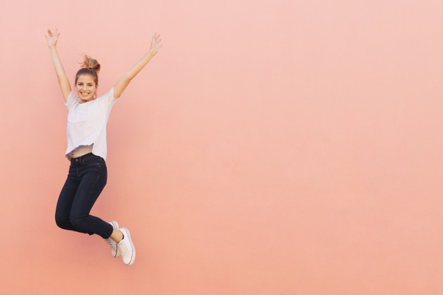 overjoyed,midair,copyspace,fashionable,length,against,agility,posing,raised,cheerful,full,casual,front,colored,smiling,stylish,pretty,one,adult,arms,facial,jumping,motion,peach,arm,lifestyle,portrait,expression,beautiful,happiness,jump,young,female,freedom,youth,life,model,person,human,happy,smile,beauty,fashion,woman,people,background