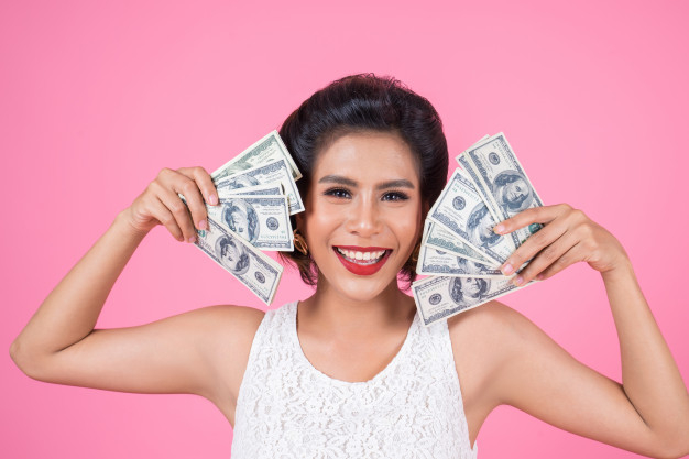 hundred,cheerful,smiling,stylish,pretty,holding,rich,lottery,currency,lifestyle,portrait,beautiful,happiness,wallet,young,female,cash,dollar,modern,winner,person,glasses,happy,shopping,pink,girl,blue,fashion,woman,money,hand