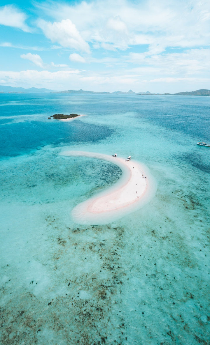 aerial shot,beach,boat,clouds,daylight,drone shot,east nusa tenggara,high angle shot,horizon,indonesia,island,komodo island,landscape,nature,ocean,outdoors,pink,pink beach,relaxation,sand,scenic,sea,seascape,seashore,shore,sky,summer,sun,travel,tropical,turquoise,vacation,view,water,watercrafts