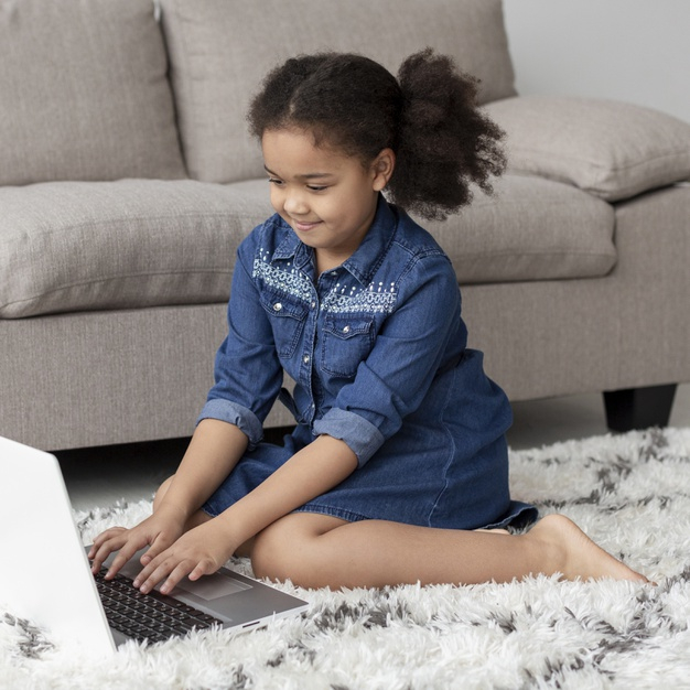indoors,electronic device,adorable,browsing,curly hair,curly,device,portrait,young,electronic,sofa,laptop,home,hair,girl
