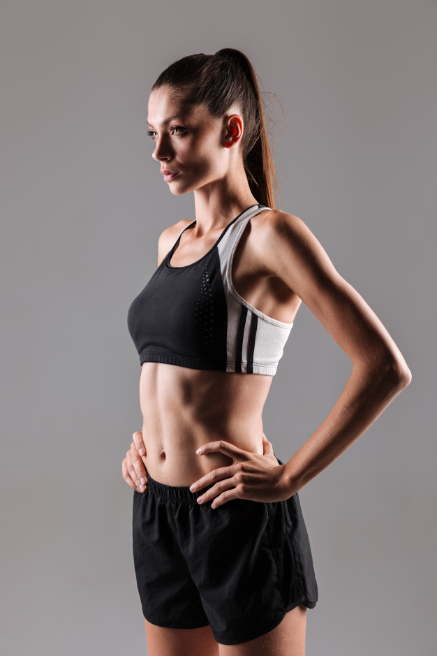 Confident Young Fit Woman In Sportswear Posing Free Stock Photo