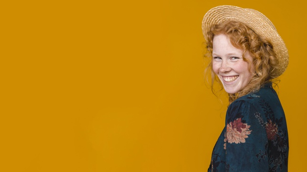 overjoyed,freckled,wicker hat,looking at camera,grinning,amused,toothy,studio shot,copy space,turned,delighted,pleased,indoors,sincere,foxy,rejoice,optimist,glad,red hair,charming,redhead,joyful,playful,straw hat,half,wicker,cheerful,leisure,looking,copy,smiling,stylish,pretty,horizontal,shot,laughing,curly,straw,positive,ginger,lovely,lifestyle,beautiful,young,female,studio,lady,funny,natural,hat,orange background,happy,orange,space,hair,red,camera,woman,background