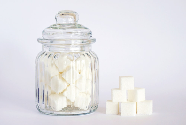 close-up,container,cubes,glass jar,jar,sugar,sugary,sweet,white background