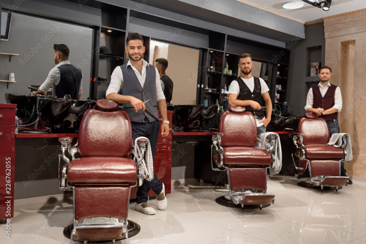 salon,hair,barbershop,scissors,master,man,bearded,photogenic,charming,positive,confident,professional,adult,standing,coiffure,beard,haircut,care,beauty,stylish,style,shop,fashion,trendy,profession,styling,equipment,uniform,wellness,indoor,male,people,three,caucasian,horizontal,front view,posing,smiling,adobestock