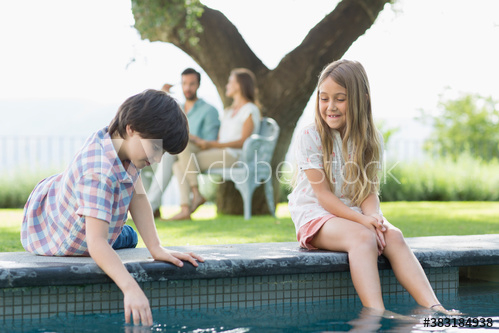 brother,sister,play,edge,swimming pool,girl,boy,man,woman,children,adult,elementary,preteen,mid,family,smile,happiness,enjoy,bonding,together,to sit,travel,vacation,summer,leisure,lifestyle,water,dip,foot,leg,outdoors,day,people,4,group,soft focus,adobestock