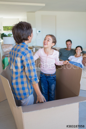 playful,brother,sister,move,cardboard,box,woman,man,girl,boy,adult,children,mid,mature,elementary,preteen,mixed race,caucasian,brazilian,together,lifestyle,domestic life,indoor,day,people,4,group,adobestock