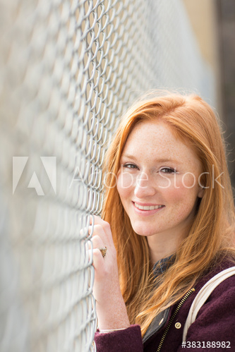 portrait,happiness,beautiful,woman,adult,young,sunny,chain link,fence,caucasian,racked,lifestyle,smile,outdoors,day,people,1,alone,adobestock