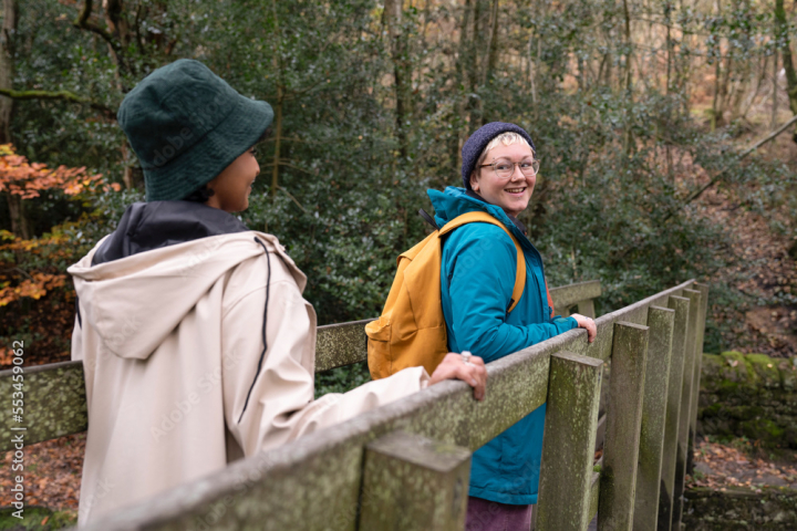 woman,girl,adult,mid,teenage,pair,bridge,hike,friendship,active,forest,nature,healthy,exploration,adventure,togetherness,leisure,relaxation,smile,enjoyment,diversity,gem,multiracial,group,britain,horizontal,outdoors,day,lifestyle,autumn,hipster,tree,jacket,backpack,hat,eyeglass,caucasian,african,2,people,adobestock