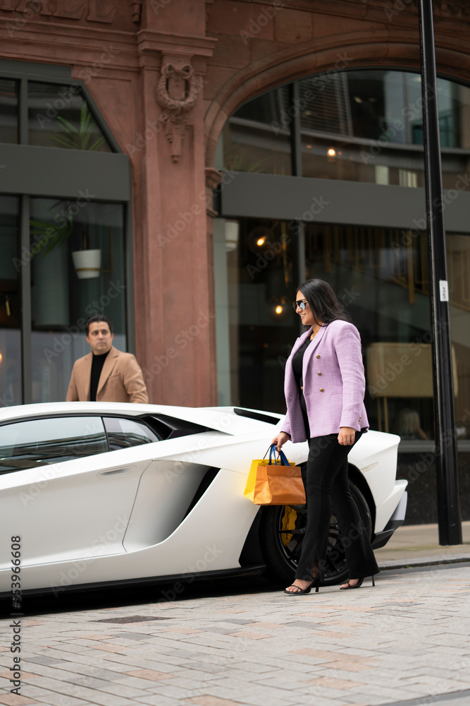 woman,man,adult,young,mature,pair,father,daughter,offspring,wealth,luxury,millionaire,upper class,bag,lifestyle,togetherness,eltern,family,children,bond,horizontal,outdoors,day,britain,gem,fashionable,multiracial,asian,2,people,adobestock