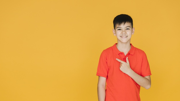 medium shot,front view,copyspace,medium,charming,showing,minimalism,gestures,little,casual,front,looking,mood,horizontal,shot,facial,gesture,emotions,expression,view,asian,emotion,young,youth,studio,teenager,modern,orange background,boy,person,orange,face,cute,background