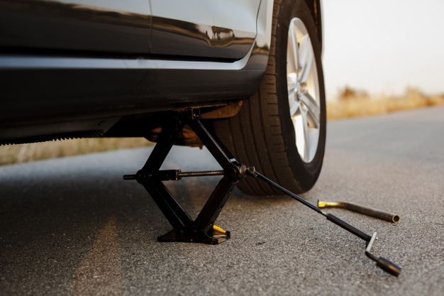 Free: Black car lifted up by a jack-screw Free Photo 