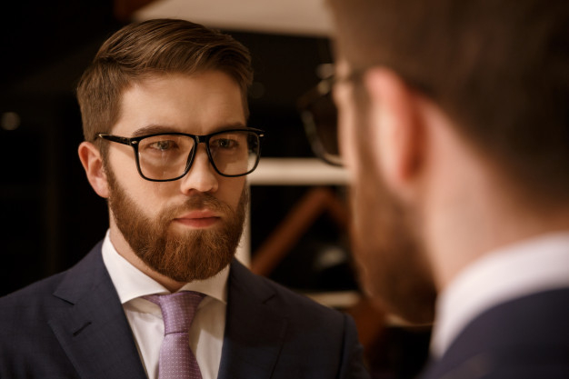 Free Photo, Young handsome man choosing clothes at shop