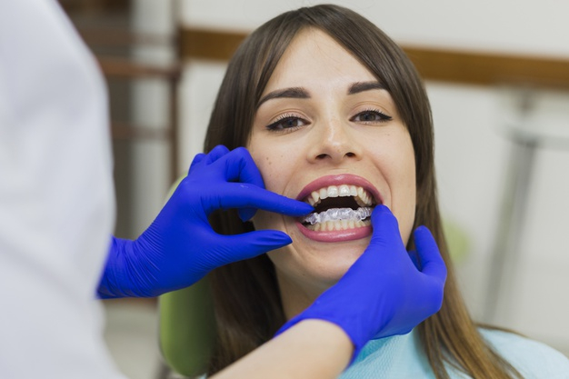 practitioner,retainers,orthodontist,surgical gloves,front view,getting,oral hygiene,invisible,stomatology,surgical,oral,defocused,close up,surgeon,front,technician,horizontal,dentistry,hygiene,close,medic,gloves,up,patient,view,female,dentist,dental,medicine,health,woman