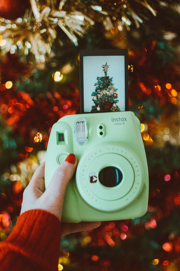 blur,christmas,christmas tree,depth of field,hand,holding,instant,instant camera,instant photo,instax,polaroid,shallow focus