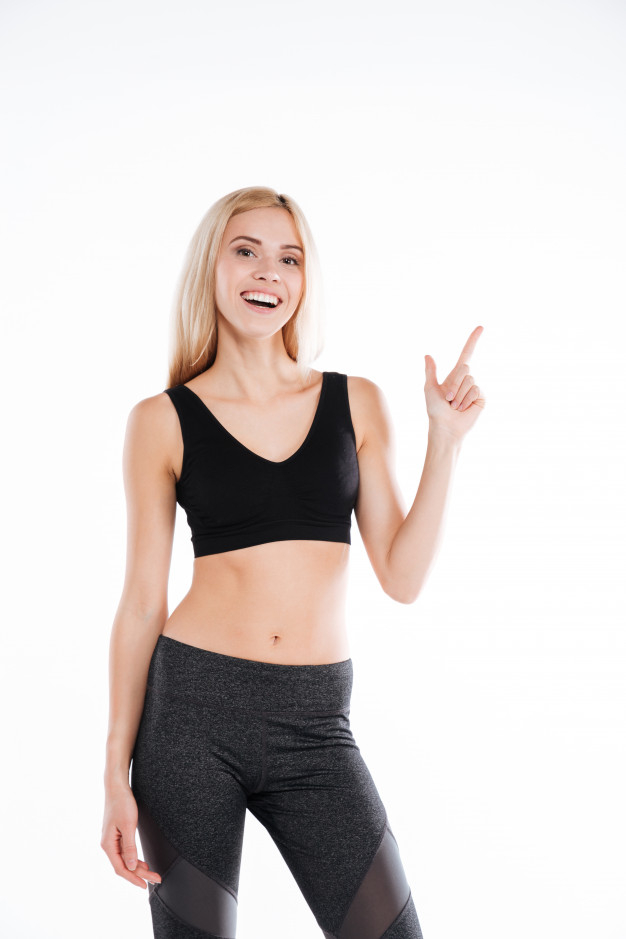 Attractive fit woman exercising in studio with copyspace