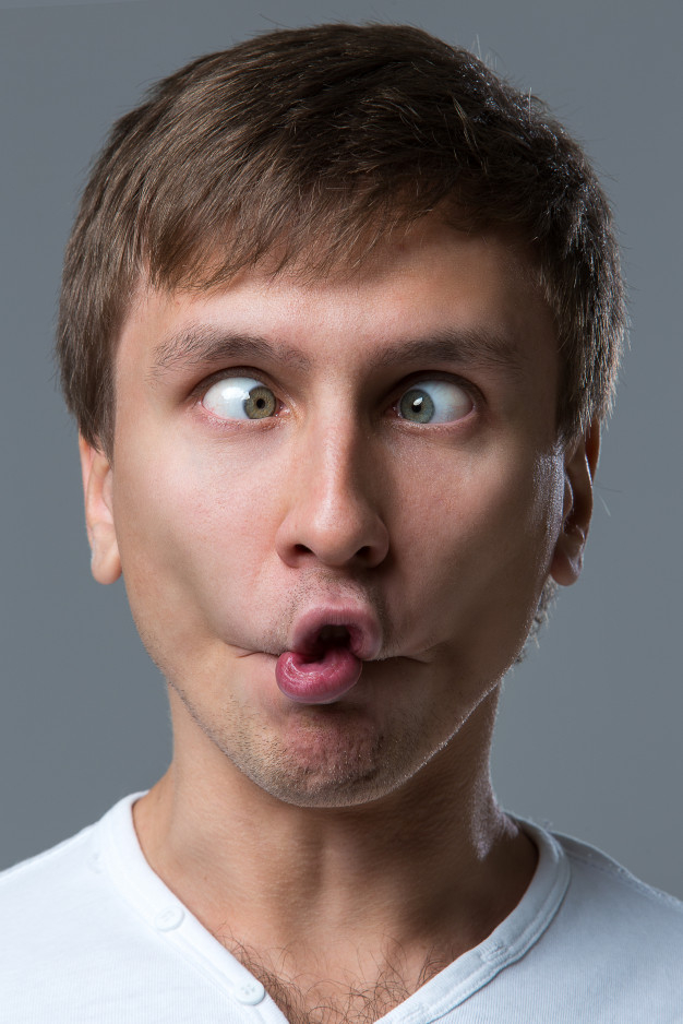 Portrait of young surprised emotional big eyes man with open mouth