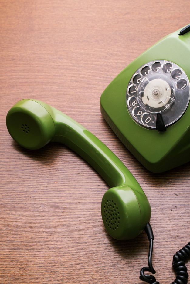 closeup,handset,rotary,aged,past,nostalgia,classical,dial,communicate,cord,curly,voice,device,antique,plastic,cable,conversation,traditional,classic,wooden,old,connection,call,talk,communication,contact,telephone,number,retro,home,table,office,phone,wood,vintage
