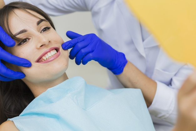 practitioner,orthodontist,surgical gloves,oral hygiene,side view,stomatology,surgical,oral,side,surgeon,smiling,technician,horizontal,dentistry,hygiene,medic,gloves,patient,view,female,dentist,dental,medicine,smile,health,woman