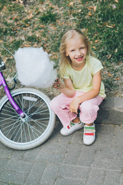 adorable,caucasian,sitting,cycling,clothes,ride,cotton candy,innocence,daytime,park,street,cute,casual,border,summer,candid,kid,city,people,cheerful,delicious,little,food,vehicle,dessert,transportation,outdoors,transport,tasty,alone,sweet,child,eating,innocent,childhood,summertime,bike,bicycle,girl,person,clothing,depositphotos