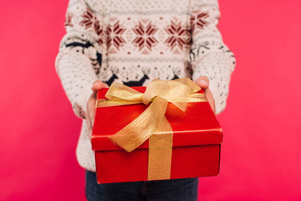 Isolated On pink,box,winter,gift box,alone,young adult,christmastime,showing,gift,xmas,christmas eve,faceless,event,cropped image,partial,selective focus,male,merry,present,Studio Shot,holiday,man,greeting,festive,merry christmas,casual,sweater,New Year,Gifting,person,people,celebration,depositphotos