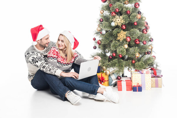 woman,Isolated On White,festive,attractive,celebration,closeness,New Year,love,event,together,togetherness,gifts,appliance,party,man,sweaters,people,girl,boyfriend,gadget,relationship,technology,xmas,christmas time,girlfriend,network,digital device,christmas eve,laptop,smiling,electronic,denim,wrapped,handsome,affectionate,presents,happy,decorations,cut out,christmas tree,Young Adults,decorated,couple,winter,seasonal,christmas,holiday,caucasian,santa claus hats,Jeans,depositphotos