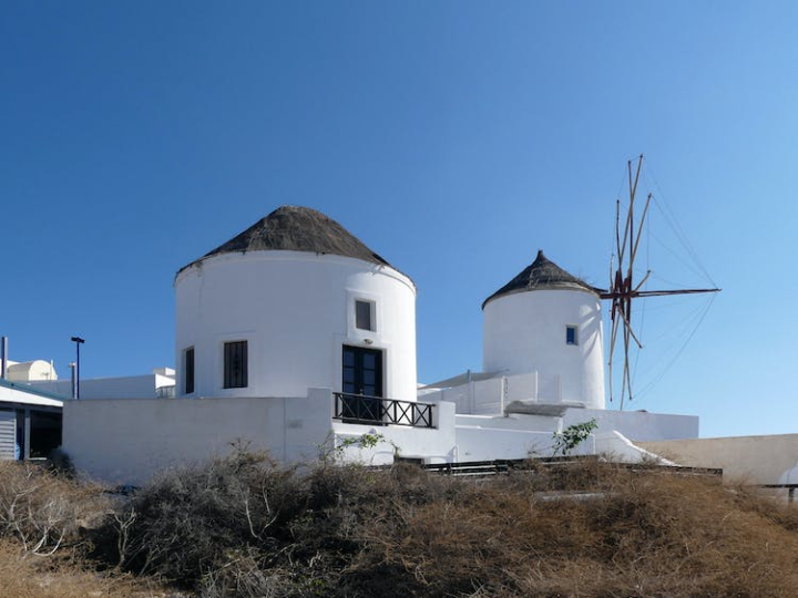 blue sky,buildings,famous landmark,fira,greece,house,landscape,santorini,tourist destination,windmill