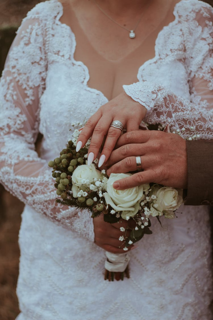 bouquet,bride,flowers,hand,hands human hands,holding,love,marriage,midsection,vertical shot,wedding dress,woman