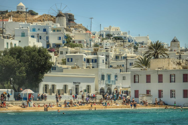 beach goers,greece,mykonos,people,seashore,spring break,summer,travel,vacation,white beach