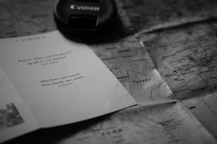 blur,canon,card,close-up,indoors,lens cover,map,papers,quote