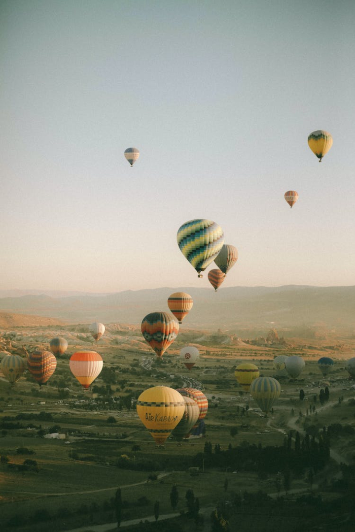 aircrafts,cappadocia,flying,hot air balloons,pastel,sky,turkey,vertical shot