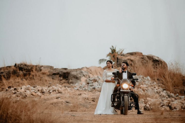 desert,dress,man,motorcycle,newlyweds,posing,standing,suit,wedding photography,woman