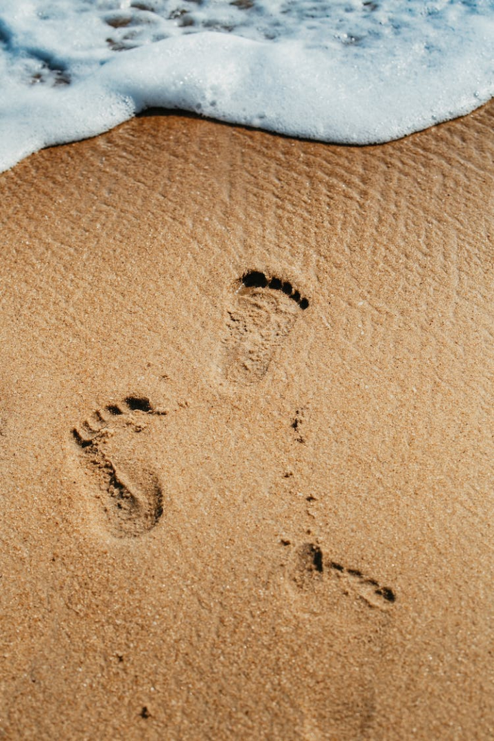 beach,beach sand,close-up,footprints,ocean,sand,sea foam,seashore,steps,vertical shot