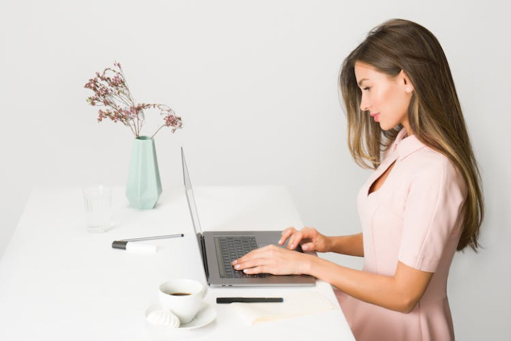 attractive,beautiful,browsing,brunette,business,computer,concentration,desk,female,front desk,girl,laptop,person,product management,product manager,remote,sitting,table,woman,working,workspace