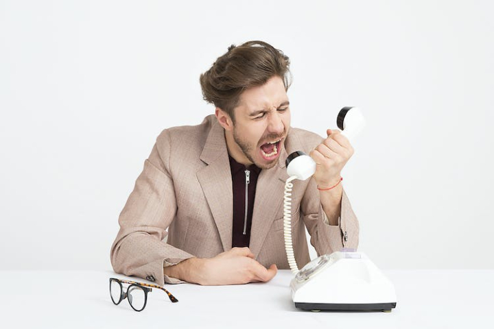 adult,angry,call,communication,customer support,desk,disappointed,eyeglasses,frustrated,glasses,help desk,mad,male,man,office,person,phone,phone call,screaming,shout,sit,sitting,spam,suit,table,telephone,white