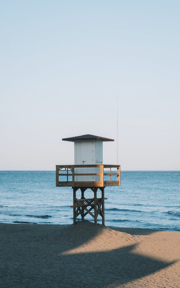 beach,blue sky,building,coast,horizon,lifeguards hut,ocean,sand,sea,shore,summer,vertical shot