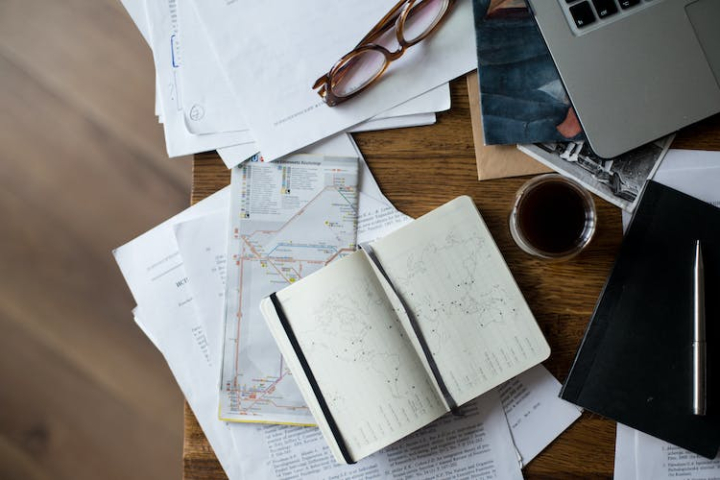 black coffee,blur,book,business,caffeine,close-up,coffee,coffee cup,cup,cup of coffee,desk,eyewear,facebook cover,flatlay,focus,indoors,laptop,maps,papers,pen,table,top view,travel,wood,wooden,work