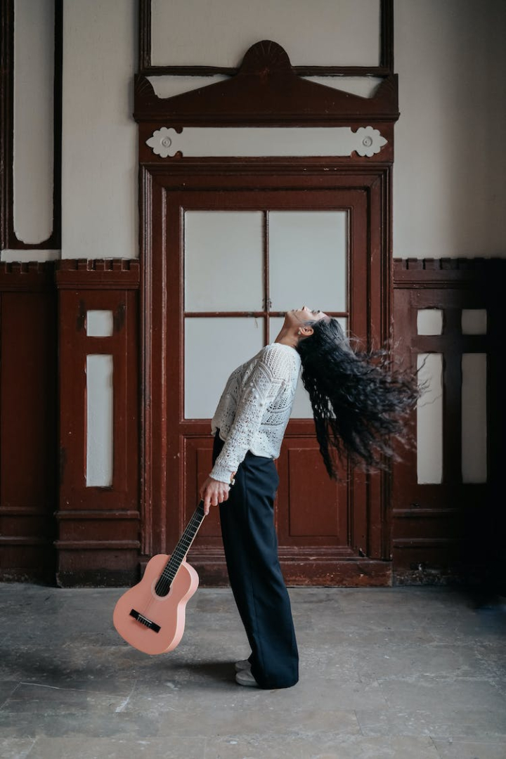 black hair,door,doors,fashion photography,guitar,holding,instrument,long hair,music,posing,standing,vertical shot,woman