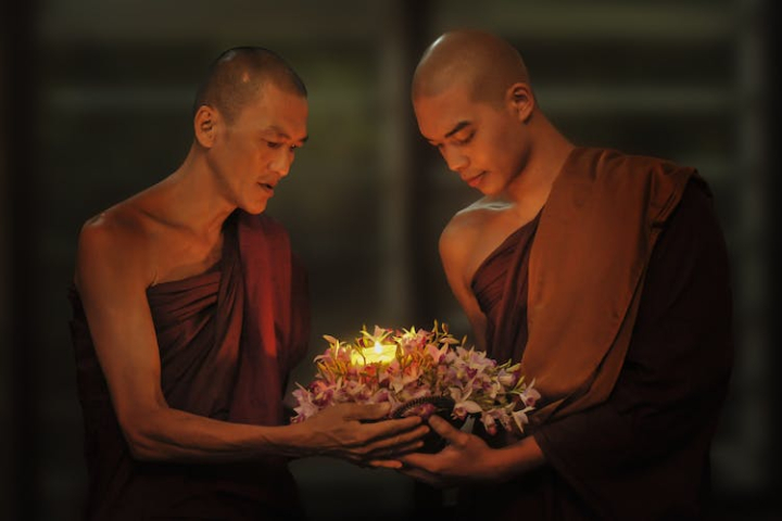 affection,blur,buddha,buddhism,candle,ceremony,close-up,facial expression,flame,flowers,focus,indoors,man,monks,people,religion,religious,spirituality,traditional,wear,worship
