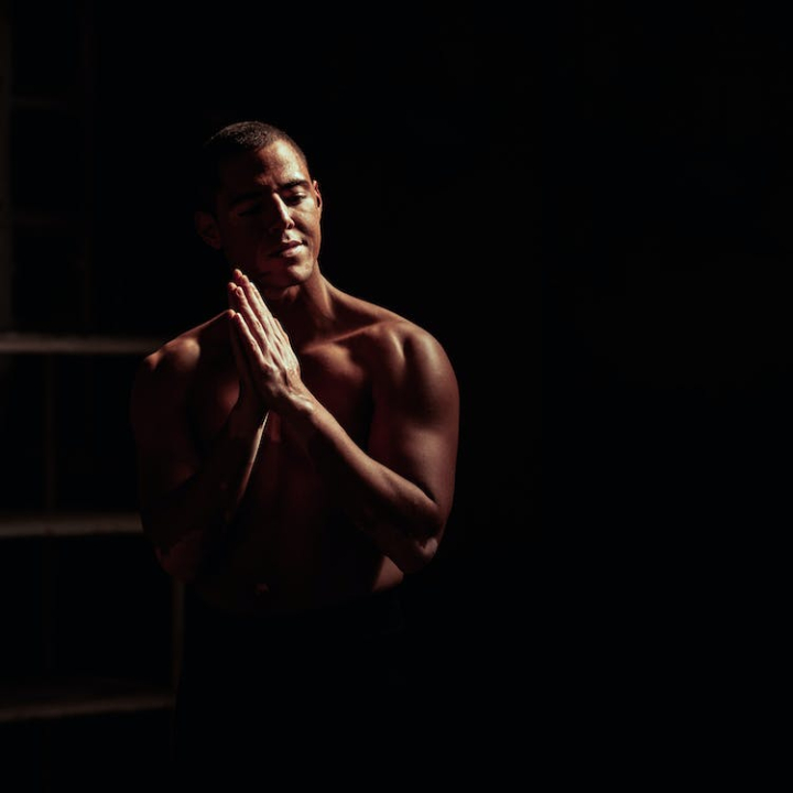 art,black background,body,brawny,dark,facial expression,fit,gesture,guy,hand gesture,hands,light,male,man,model,muscles,naked,namaste,nude,person,photoshoot,portrait,pose,prayer,religion,sexy,sexy man,shirtless,skin,studio,topless