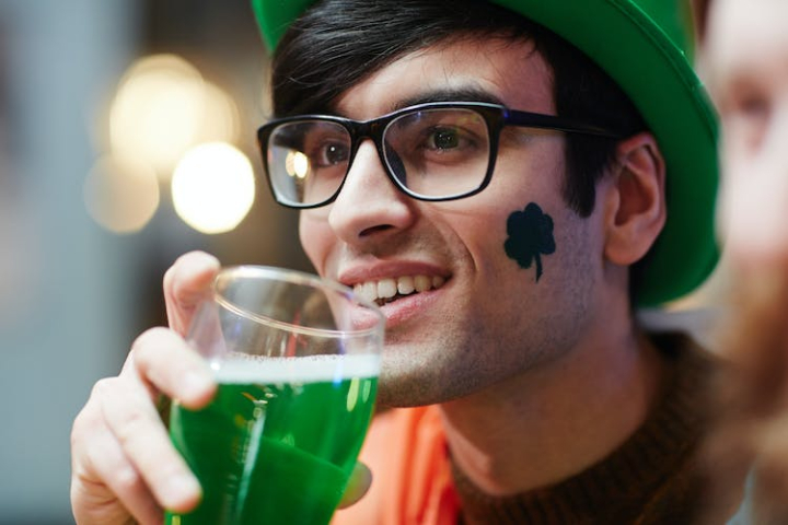adult,attention,beer,celebration,close-up,clover,drink,enjoying,eyeglasses,eyewear,face,fan,glass,green,green beer,green hat,happy,holiday,irish,man,occasion,pastime,patrick,portrait,saint patrick s day,shamrock,smiley,smiling,st patrick s day,symbol,toothy,tradition,watching