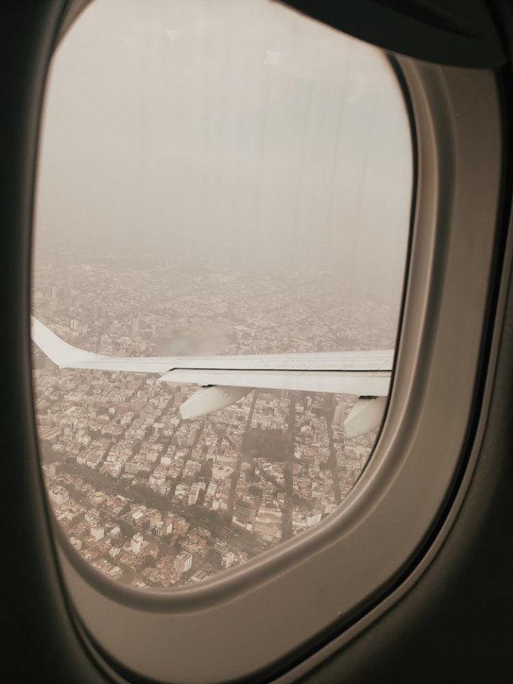 aircraft,airplane,airplane wing,aviation,blur,flight,flying,fog,foggy,landscape,sky,vehicle,vertical shot,view,window