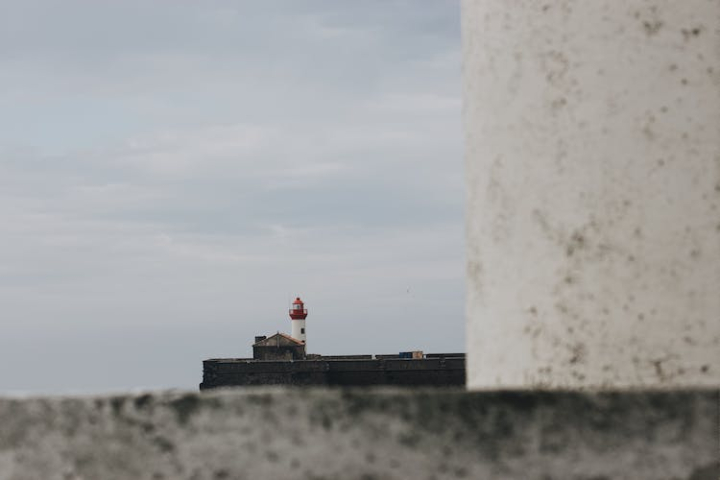 architecture,beacon,blur,building,cloudy,coast,coastline,concrete,construction,destination,direction,distant,embankment,gloomy,gray,guide,infrastructure,lighthouse,location,marine,nautical,navigate,outdoors,overcast,port,remote,rough,safety,seafront,seashore,seaside,security,shore,signal,sky,skyline,stone,structure,tourism,tower,travel