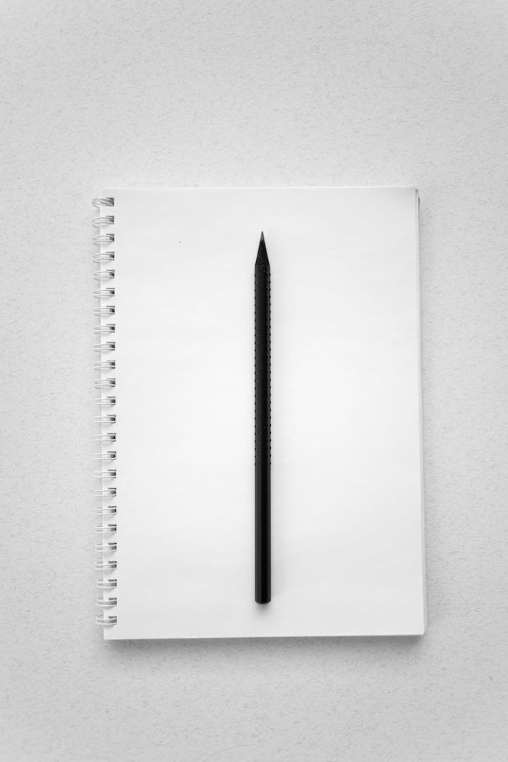 blank,empty,flatlay,high angle shot,mockup,page,pen,spiral notebook,stationery,vertical shot,white paper,white surface