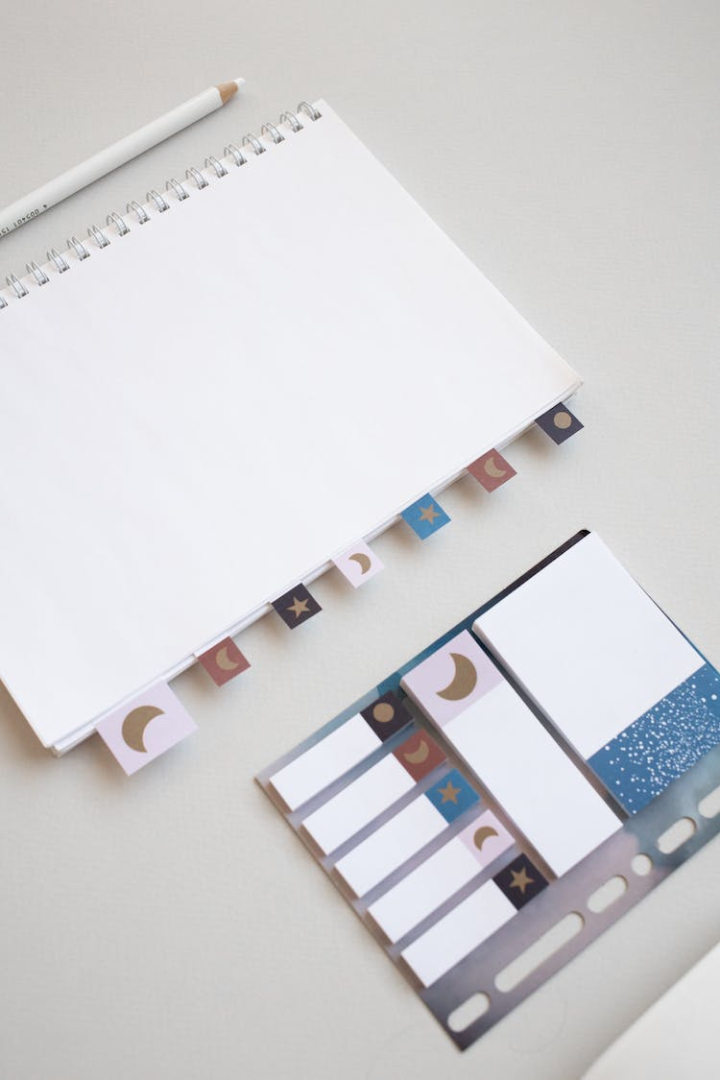 blank page,empty,flatlay,mockup,notepad,spiral notebook,stationery,sticky notes,tags,top view,vertical shot,white paper,white surface