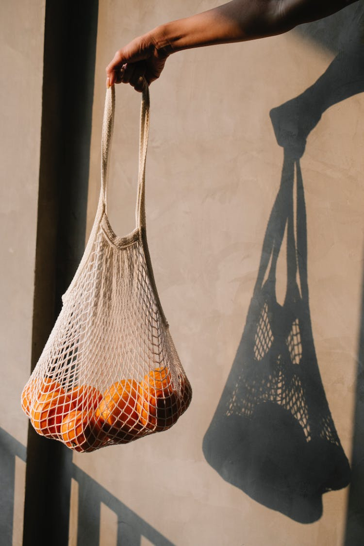 anonymous,appetizing,bag,body part,citrus,colorful,crop,delicious,eco,eco friendly,edible,faceless,flavor,food,fresh,fruit,hand,healthy,healthy food,heap,light,many,material,natural,nutrient,orange,organic,outside,person,pile,product,ripe,shadow,stack,string,sunlight,sunshine,tasty,unpeeled,unrecognizable,vertical shot,vitamin,wall,white,whole