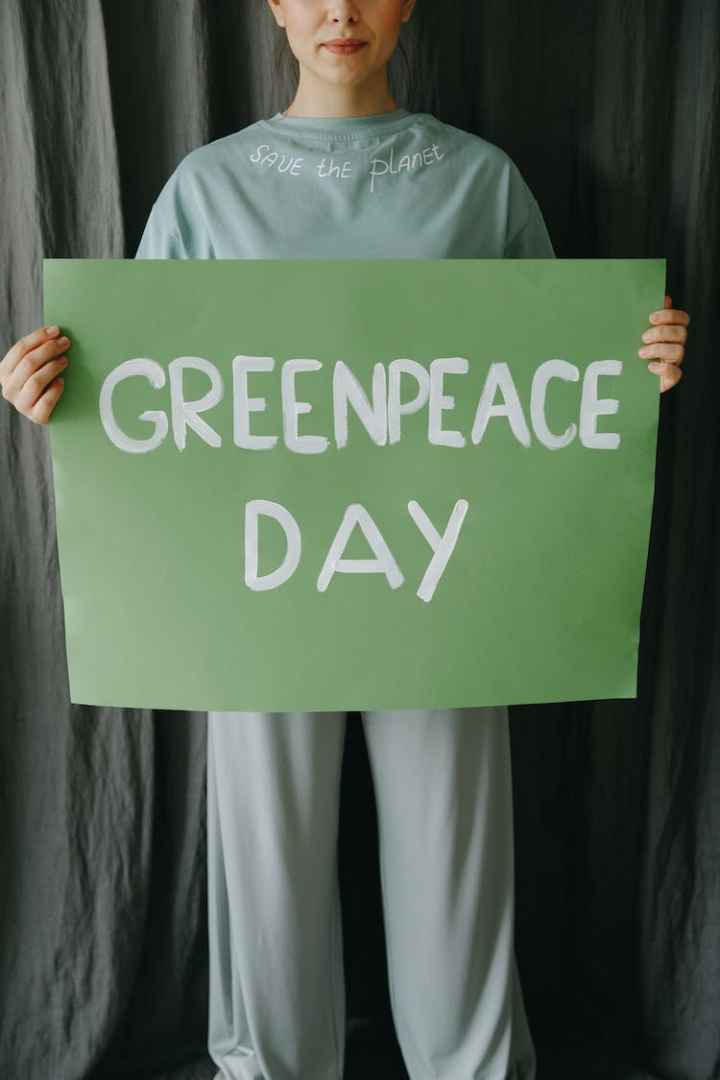 conceptual,environment,environmental protection,environmentalist,greenpeace,greenpeace day,holding,message,portrait,poster,save the planet,sign,slogan,vertical shot,woman