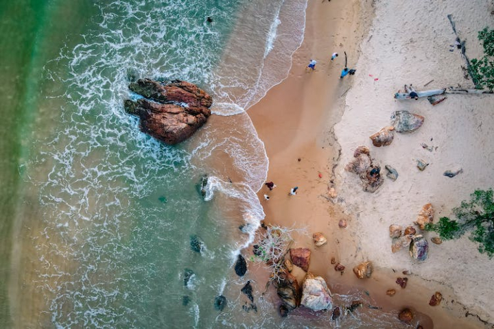 aerial photography,beach,clear water,drone shot,nature,ocean,people,rock formations,rocks,sand,scenery,scenic,sea,sea foam,seascape,seashore,top view,waves