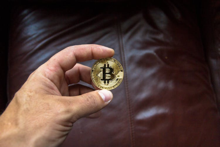 bitcoin,blockchain,close-up,coin,commerce,crypto,cryptocurrency,gold,hand,holding,leather,man,metal,person,steel,symbol